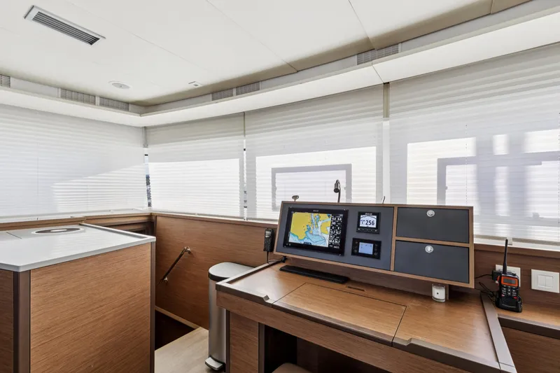 Slide: The Image of Modern navigation station on 2022 Lagoon 52 F yacht with advanced equipment and sleek design. - 34