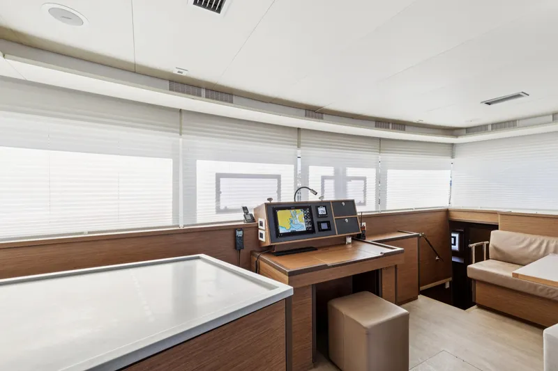 Slide: The Image of Modern interior of 2022 Lagoon 52 F yacht with navigation station and seating area. - 35