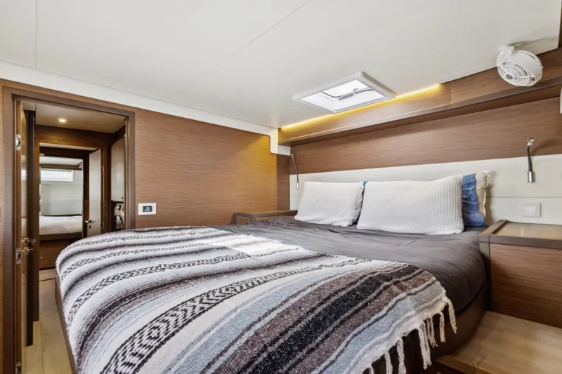 Slide: The Image of Luxurious cabin interior of 2022 Lagoon 52 F yacht with cozy bedding and modern design. - 38