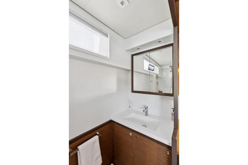 Slide: The Image of Modern bathroom interior on 2022 Lagoon 52 F yacht, featuring sleek design and wooden accents. - 45