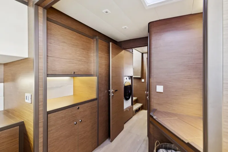Slide: The Image of Interior of 2022 Lagoon 52 F yacht with modern wood finish and built-in appliances. - 48