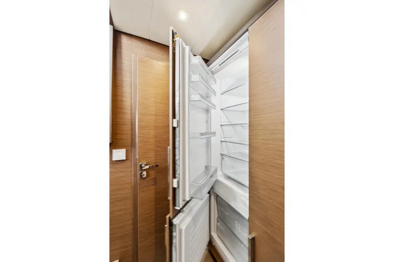 Slide: The Image of Open refrigerator inside 2022 Lagoon 52 F yacht, showcasing modern interior design. - 50