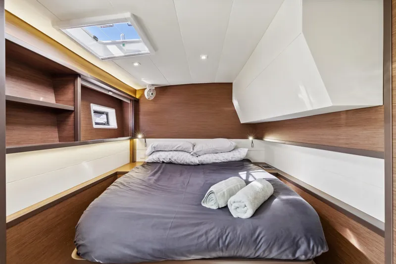 Slide: The Image of Luxurious cabin interior of 2022 Lagoon 52 F yacht with cozy bedding and modern design. - 51