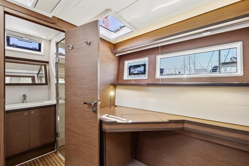 Slide: The Image of Luxurious interior of 2022 Lagoon 52 F yacht with modern wood finish and ample natural light. - 54