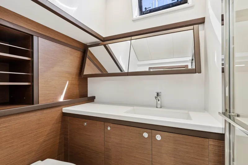 Slide: The Image of Modern bathroom interior on 2022 Lagoon 52 F yacht, featuring wood accents and sleek fixtures. - 55