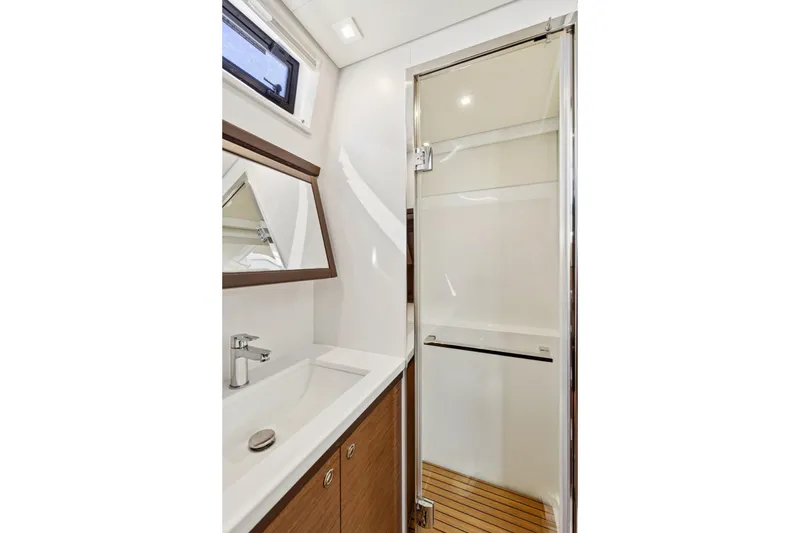 Slide: The Image of Luxurious bathroom in 2022 Lagoon 52 F yacht with modern fixtures and wooden accents. - 56