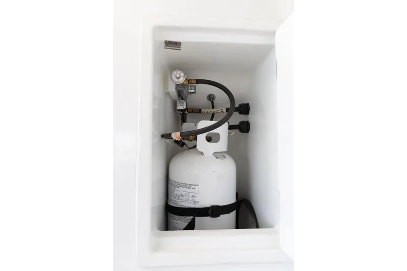 Slide: The Image of Propane tank compartment on 2022 Lagoon 52 F yacht, featuring secure fittings and connections. - 57