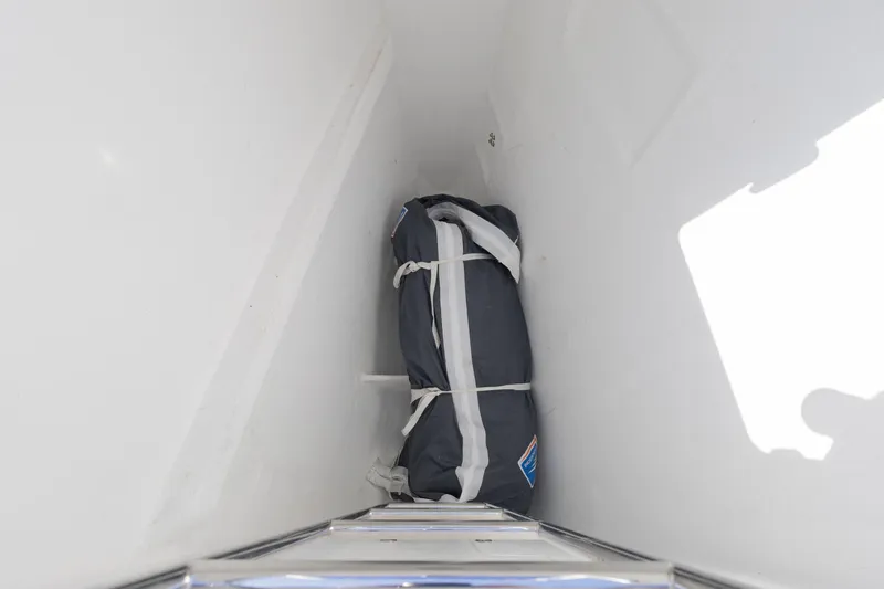 Slide: The Image of Storage compartment on 2022 Lagoon 52 F yacht with secured bag inside. - 58