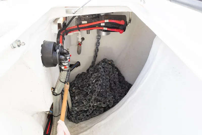 Slide: The Image of Anchor chain compartment of 2022 Lagoon 52 F yacht, featuring cables and hoses. - 59