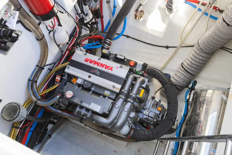 Slide: The Image of Engine compartment of a 2022 Lagoon 52 F yacht with Yanmar engine and various components. - 63