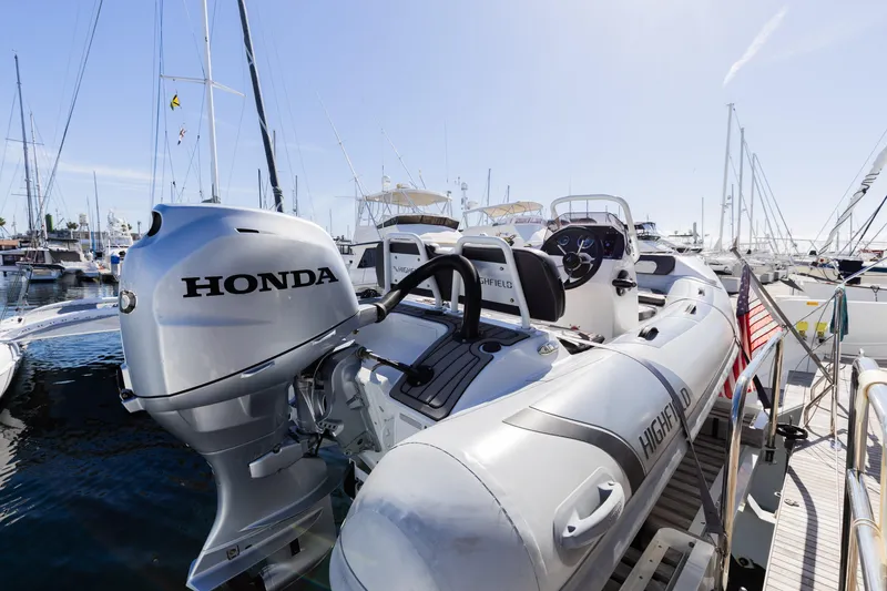 Slide: The Image of Lagoon 52 F 2022 yacht with Honda outboard motor and Highfield tender at marina. - 68