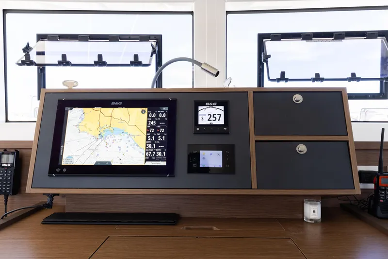 Slide: The Image of Navigation console of 2022 Lagoon 52 F yacht with modern instruments and displays. - 73