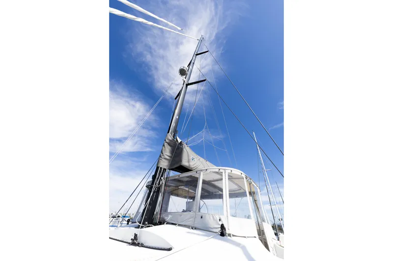 Slide: The Image of Sailing yacht Lagoon 52 F, 2022 model, with mast and sails against a blue sky. - 79