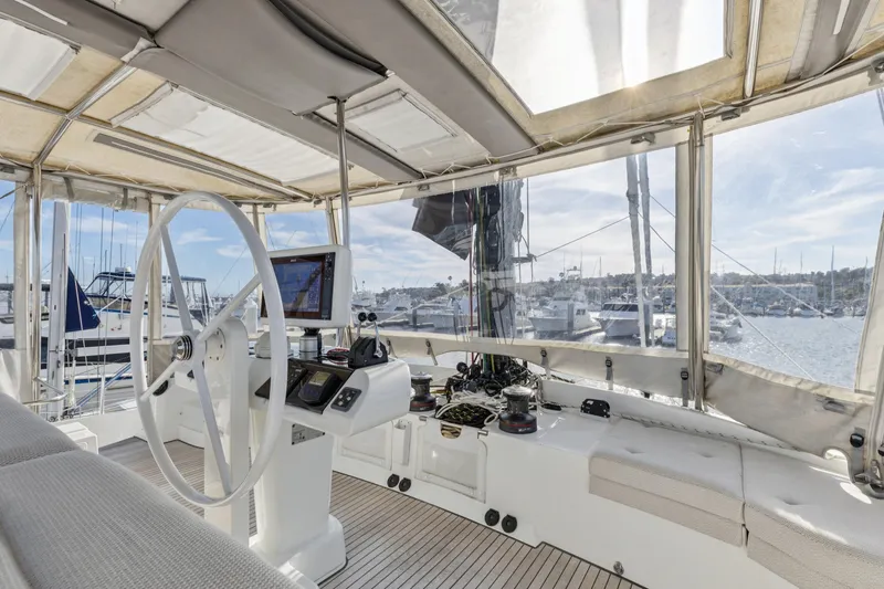 Slide: The Image of Interior view of 2022 Lagoon 52 F yacht helm with marina background. - 8