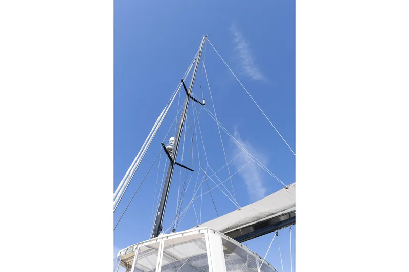 Slide: The Image of Mast and rigging of 2022 Lagoon 52 F catamaran against clear blue sky. - 86