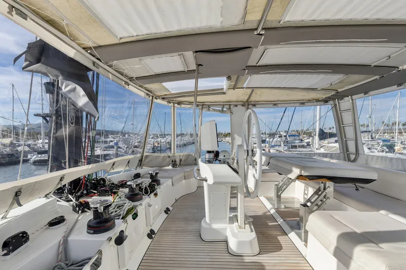 Slide: The Image of Interior view of 2022 Lagoon 52 F catamaran with helm and seating area in marina. - 9