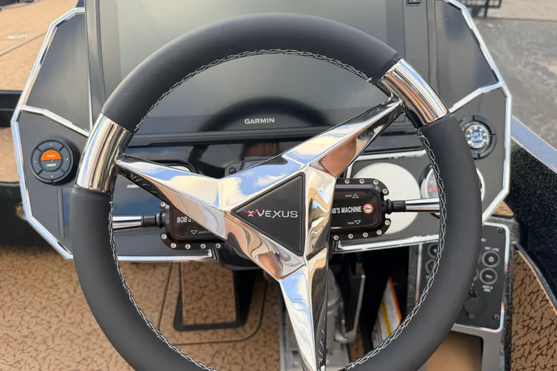 Slide: The Image of Steering wheel of 2026 Vexus VXs21 boat with Garmin display and controls. - 11