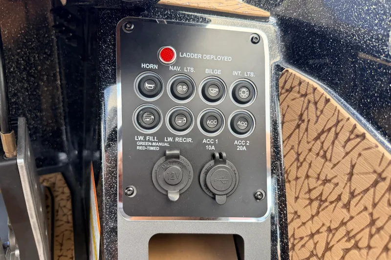 Slide: The Image of Control panel of 2026 Vexus VXs21 boat with various switches and indicators. - 13