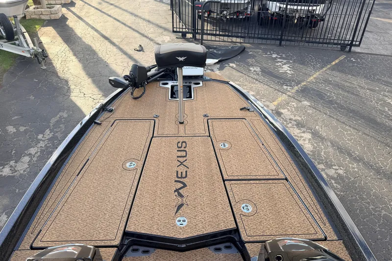 Slide: The Image of 2026 Vexus VXs21 boat deck with Garmin equipment, parked on a paved surface. - 29