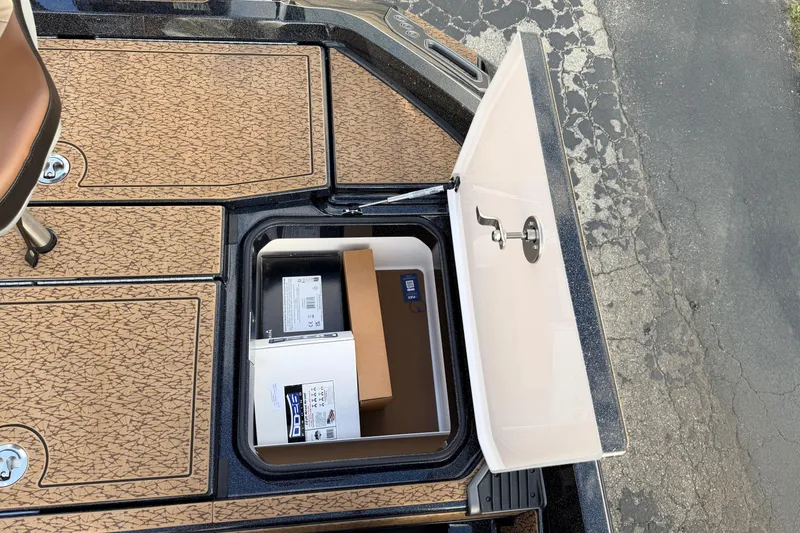 Slide: The Image of Open storage compartment on 2026 Vexus VXs21 boat, revealing organized interior space. - 42