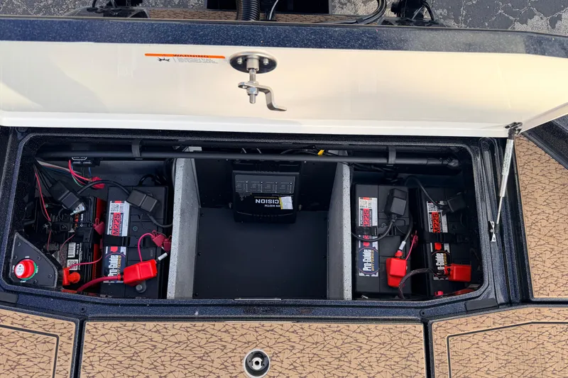 Slide: The Image of Open battery compartment of 2026 Vexus VXs21 boat, showcasing Pro-Guide batteries and wiring. - 44