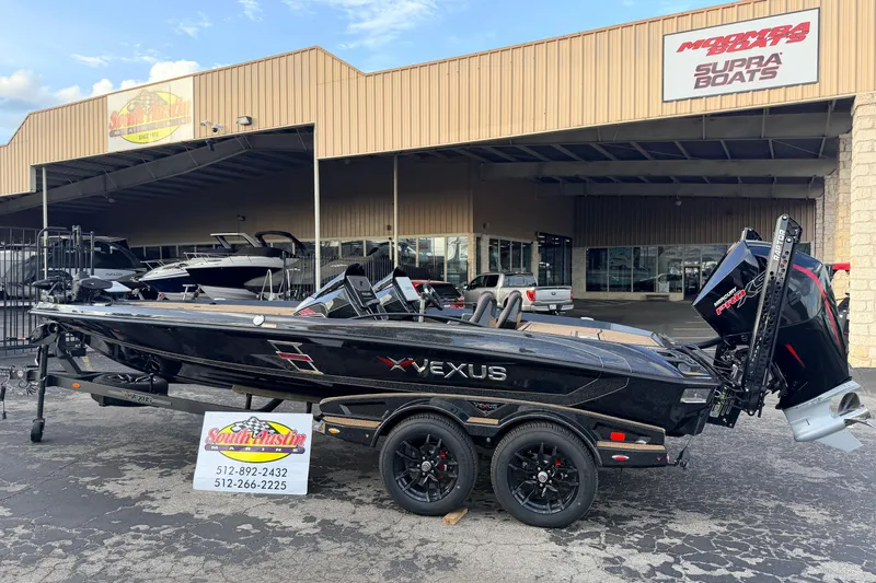 Slide: The Image of 2026 Vexus VXs21 boat displayed outside dealership, featuring sleek black design and powerful engine. - 46