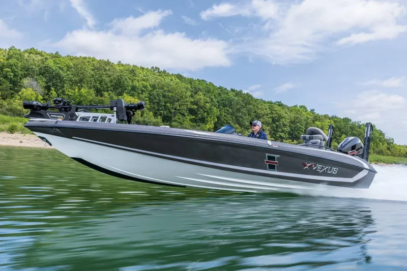 Slide: The Image of Manufacturer Provided Image: 2026 Vexus VXs21 boat cruising on a lake with lush green forest backdrop. - 47