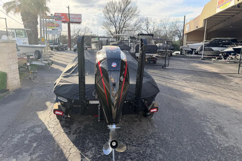 Slide: The Image of 2026 Vexus VXs21 boat with cover, parked outdoors near dealership. - 5
