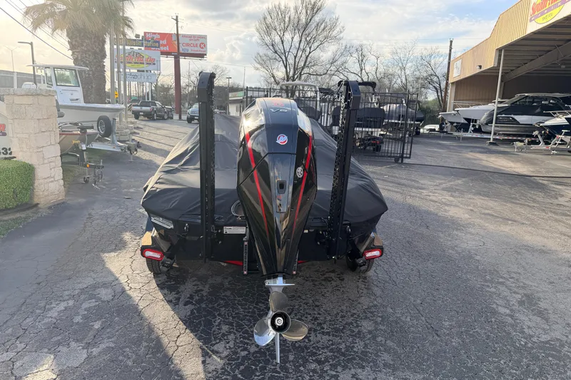 Slide: The Image of 2026 Vexus VXs21 boat with cover, parked at a dealership. - 6