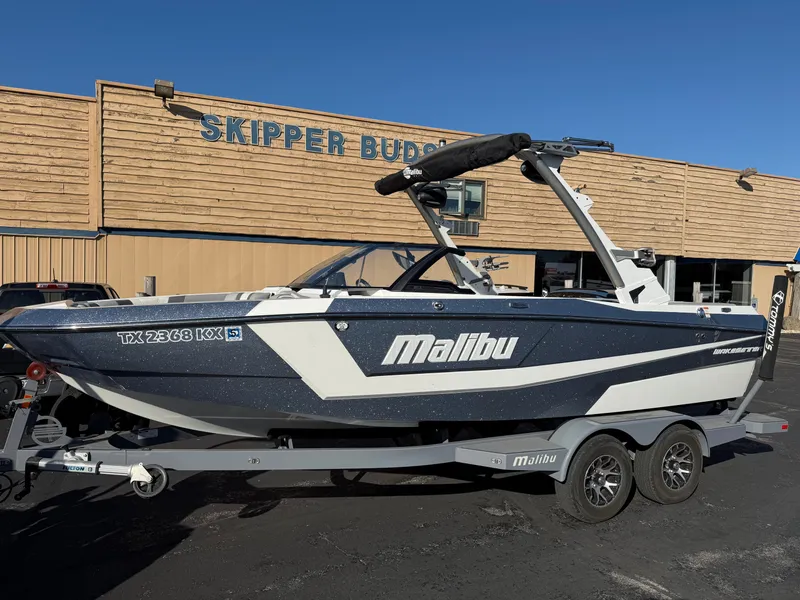 Slide: The Image of 2022 Malibu Wakesetter 21 LX boat in front of Skipper Bud's building. - 2