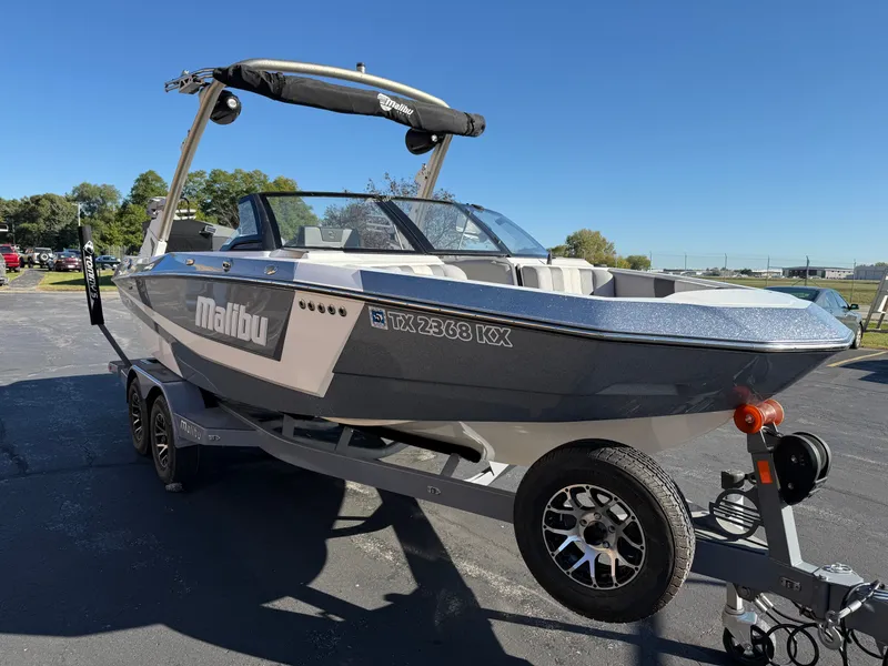 Slide: The Image of 2022 Malibu Wakesetter 21 LX boat on trailer, sunny day. - 25