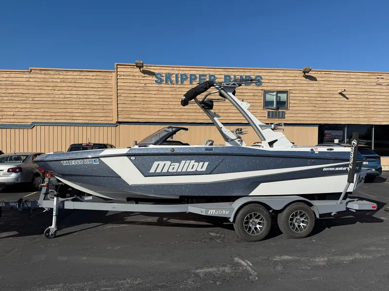 Slide: The Image of 2022 Malibu Wakesetter 21 LX boat in front of Skipper Buds building. - 28