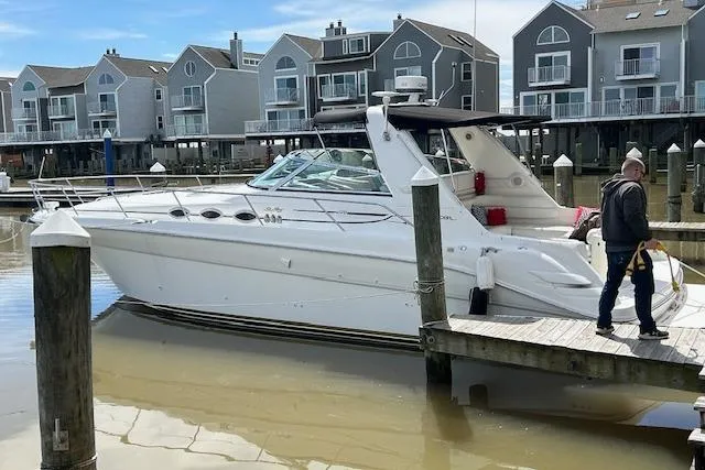 The Image of 1998 Sea Ray Sundancer 370 docked at marina with waterfront homes in background. - 0
