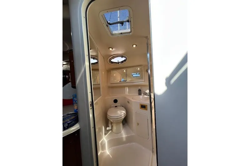 Slide: The Image of 1998 Sea Ray Sundancer 370 yacht bathroom interior with skylight and modern fixtures. - 12