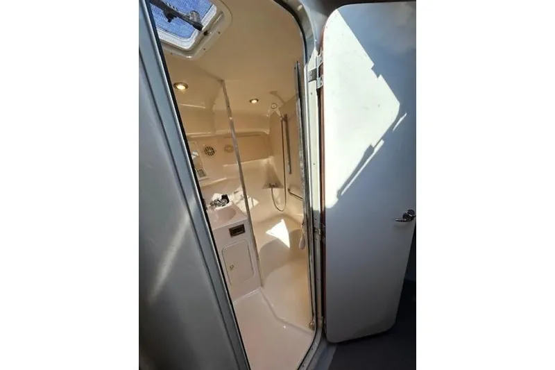 Slide: The Image of 1998 Sea Ray Sundancer 370 bathroom interior with shower and sink. - 13