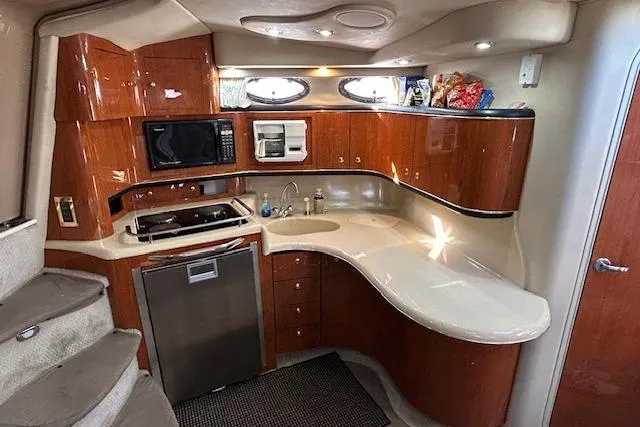Slide: The Image of Luxurious 1998 Sea Ray Sundancer 370 yacht kitchen with modern amenities and sleek design. - 7