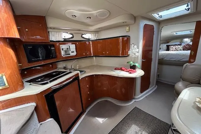 Slide: The Image of Interior of a 1998 Sea Ray Sundancer 370 yacht with kitchen and cozy cabin. - 8