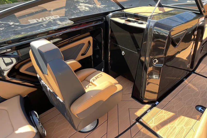 Slide: The Image of 2026 Yamaha Boats 255XD interior with sleek black and tan design, featuring modern seating. - 10