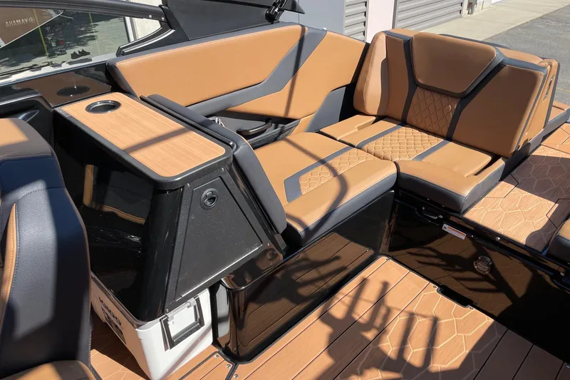 Slide: The Image of 2026 Yamaha Boats 255XD interior with tan and black seating, featuring modern design and cup holder. - 7
