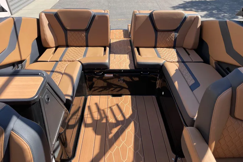 Slide: The Image of 2026 Yamaha Boats 255XD interior with tan and black seating, showcasing luxury design. - 8