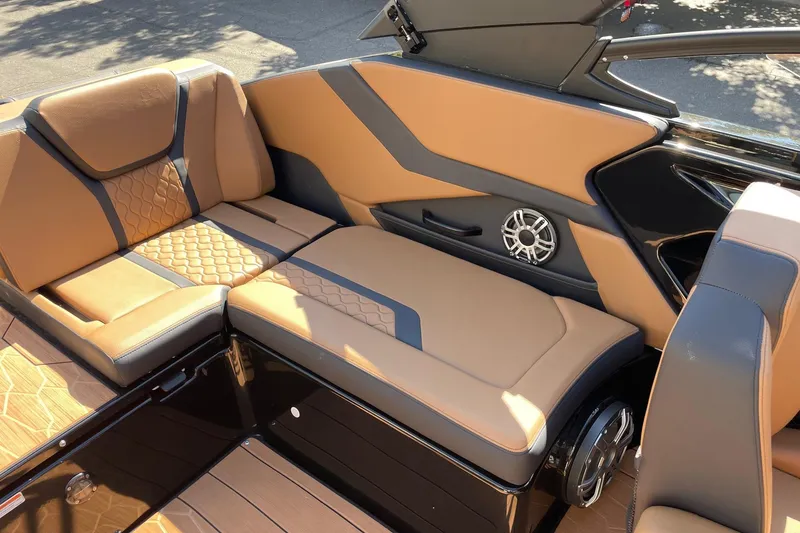 Slide: The Image of 2026 Yamaha Boats 255XD interior with tan and black seating, featuring modern design and speaker system. - 9