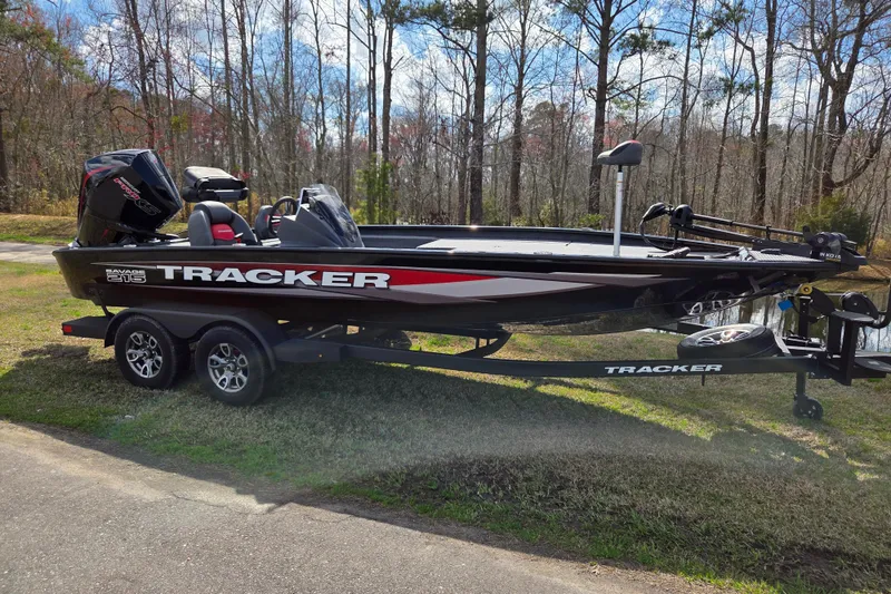 The Image of 2025 Tracker Savage 215 boat on trailer, parked outdoors near trees. - 0