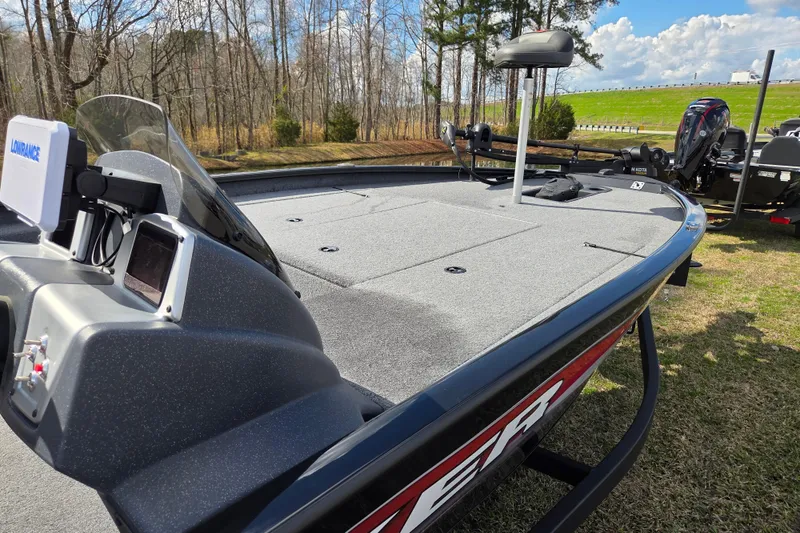 Slide: The Image of 2025 Tracker Savage 215 boat on grass, featuring advanced navigation equipment. - 8