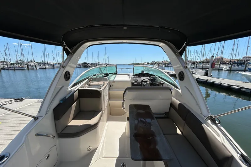 Slide: The Image of 2014 Sea Ray Sundancer 260 boat on trailer under clear blue sky. - 12