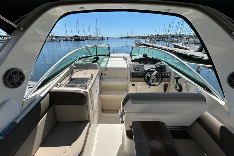 Slide: The Image of 2014 Sea Ray Sundancer 260 boat on trailer under clear blue sky. - 14
