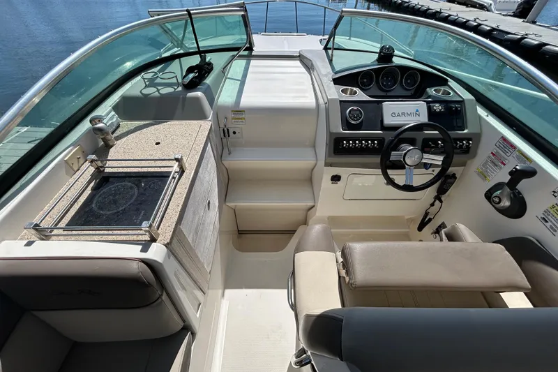 Slide: The Image of 2014 Sea Ray Sundancer 260 boat on display with anchor, sunny backdrop. - 15