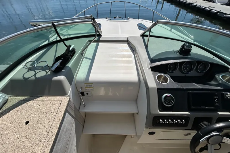 Slide: The Image of 2014 Sea Ray Sundancer 260 boat on trailer, front view, with sale banner. - 16