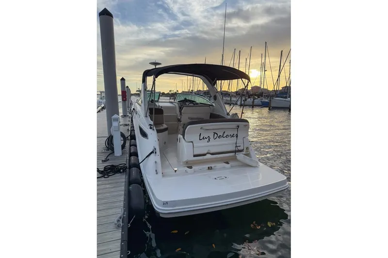Slide: The Image of 2014 Sea Ray Sundancer 260 docked at sunset, marina background. - 2