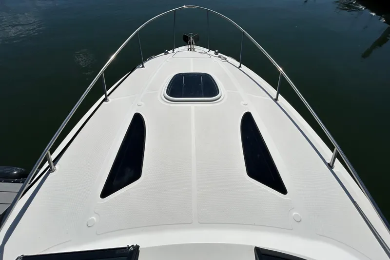 Slide: The Image of 2014 Sea Ray Sundancer 260 boat interior with seating and table, docked at marina. - 20