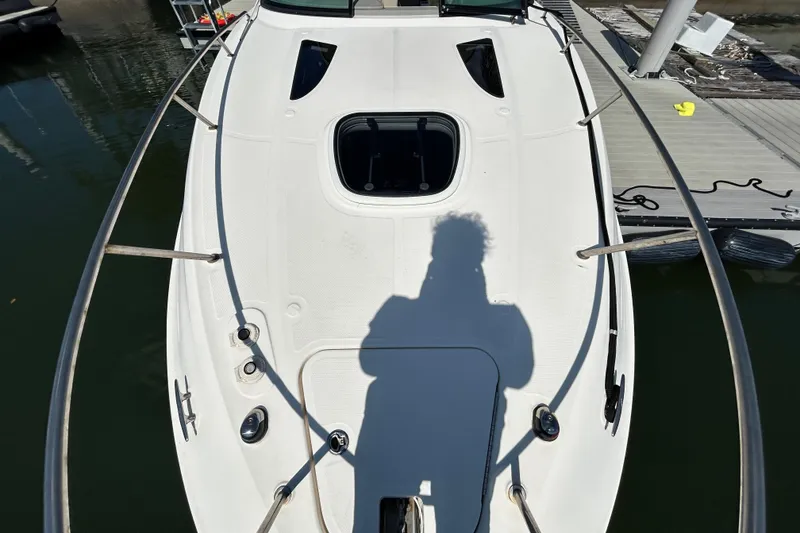 Slide: The Image of 2014 Sea Ray Sundancer 260 interior with seating and wooden table. - 23